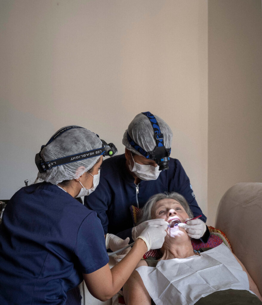 Dentista atendendo paciente idoso em casa no Rio de Janeiro